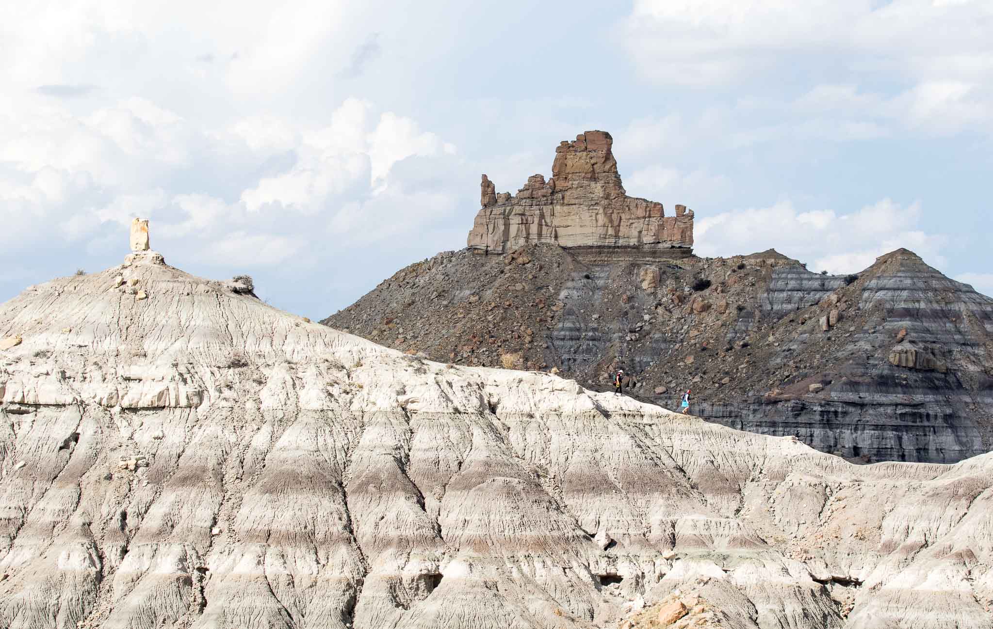 Hikers on the ridge in front of Angel Peak, Bloomfield NM, October 19, 2015